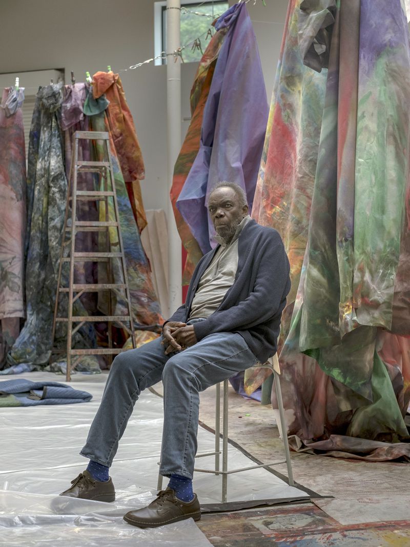 FILE — The artist Sam Gilliam in his studio in Washington on May 17, 2018. Gilliam, a pioneering abstract painter best known for his lusciously stained Drape paintings that took his medium more fully into three dimensions than any other artist of his generation, and who in 1972 became the first Black artist to represent the United States at the Venice Biennale, died on Saturday, June 25, 2022, at his home in Washington. He was 88. (Gabriella Demczuk/The New York Times)
