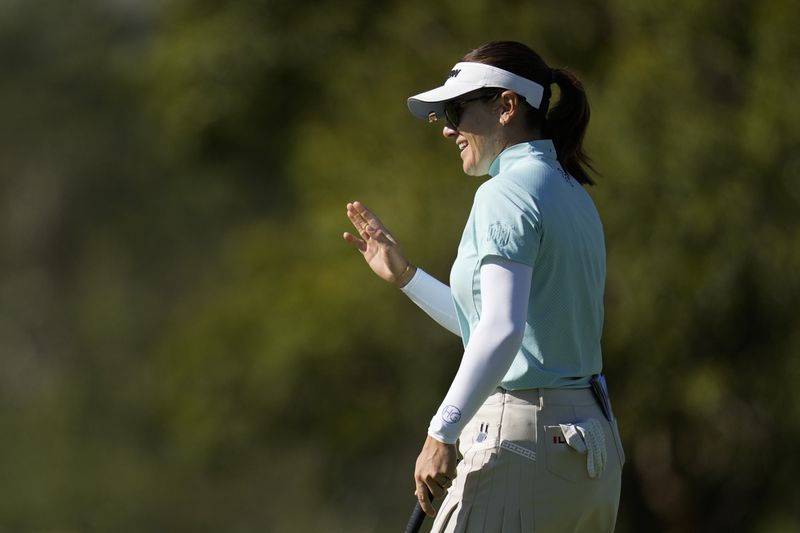 Hannah Green waves after making a putt on the 13th green during the third round of the LPGA's JM Eagle LA Championship golf tournament at Wilshire Country Club, Saturday, April 27, 2024, in Los Angeles. (AP Photo/Ashley Landis)