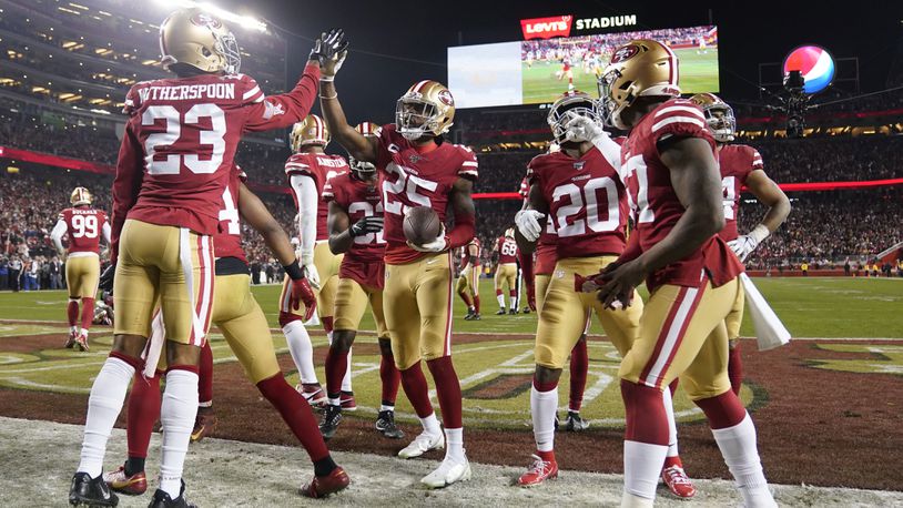 San Francisco 49ers players celebrate after cornerback Richard Sherman (center) intercepted a pass against the Green Bay Packers during the second half of the NFC Championship game Sunday, Jan. 19, 2020, in Santa Clara, Calif. The 49ers won 37-20 to advance to Super Bowl 54 against the Kansas City Chiefs.
