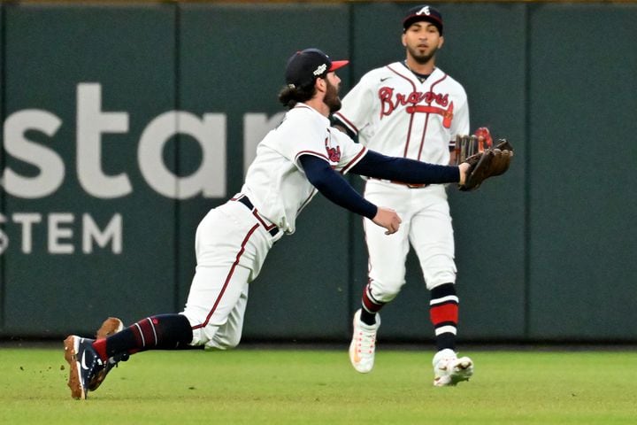 Atlanta Braves shortstop Dansby Swanson (7) makes an over the shoulder catch of the popup by Philadelphia Phillies’ J.T. Realmuto during the sixth inning of game two of the National League Division Series at Truist Park in Atlanta on Wednesday, October 12, 2022. (Hyosub Shin / Hyosub.Shin@ajc.com)