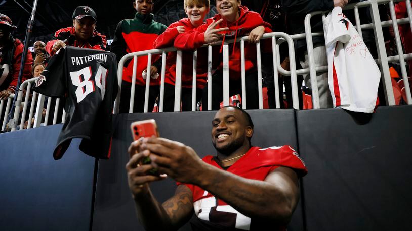 Falcons running back Cordarrelle Patterson takes a selfie with fans after Atlanta defeated the Bears 27-24 on Sunday at Mercedes-Benz Stadium. (Miguel Martinez / miguel.martinezjimenez@ajc.com)