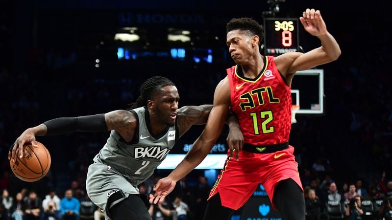 Nets forward Taurean Prince (2) drives past Hawks rookie De'Andre Hunter during the first half Saturday, Dec. 21, 2019, at Barclays Center in New York.
