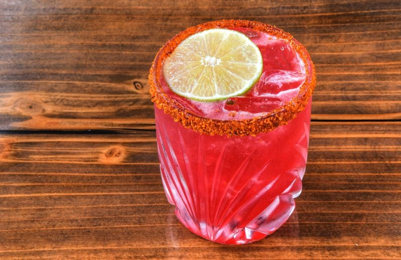 One of the cocktails at Antiguo Lobo is El Melvin, hibiscus-infused Banhez mezcal, lime, orange, agave and Tajín. (Chris Hunt for The Atlanta Journal-Constitution)