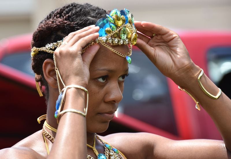 May 27, 2017 Decatur - Participant adjusts her hairband before Atlanta Caribbean Carnival Parade May 2017. HYOSUB SHIN / HSHIN@AJC.COM