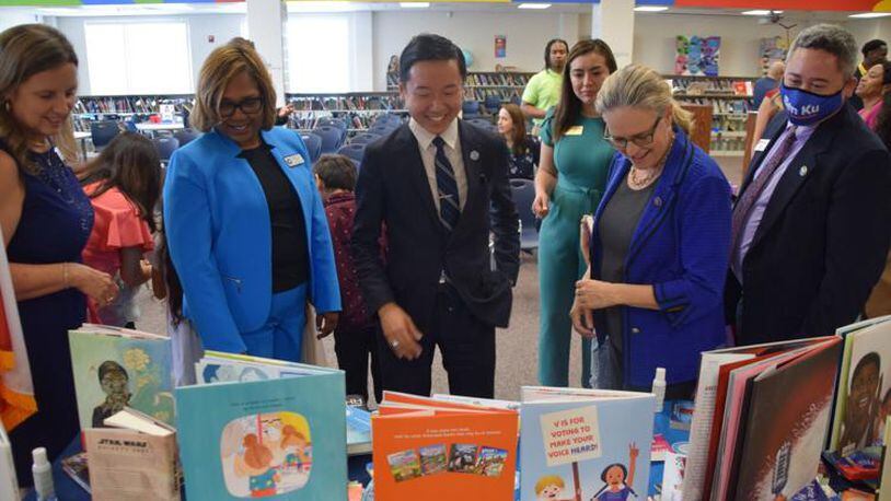 J.T. Wu, center. the founder of literacy education nonprofit, Preface, talks to Graves Elementary School officials, including Principal Monica Ball, second from the left, as well as U.S. Rep. Carolyn Bourdeaux, second from the right, and Gwinnett County Commissioner Ben Ku, right, about the multilingual books that Preface donated to the school's library. (Courtesy of Curt Yeomans)