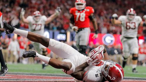 Former Alabama wide receiver Calvin Ridley lands on his back after successfully catching a touchdown pass during the fourth quarter of the College Football Playoff National Championship game at Mercedes-Benz stadium Jan. 8.