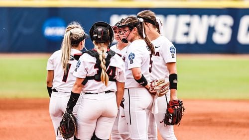 Georgia softball players rally around pitcher Mary Wilson Avant (5) when she ran into trouble in the late innings against No. 1 Oklahoma in the Women's College World Series on Saturday  USA Softball Hall of Fame Stadium in Oklahoma City, Okla., on Saturday, June 5, 2021. (Photo by Tony Walsh/UGA Athletics)
