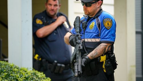 A Kennesaw State University police officer stands armed outside the Austin Residence Complex on Thursday afternoon.