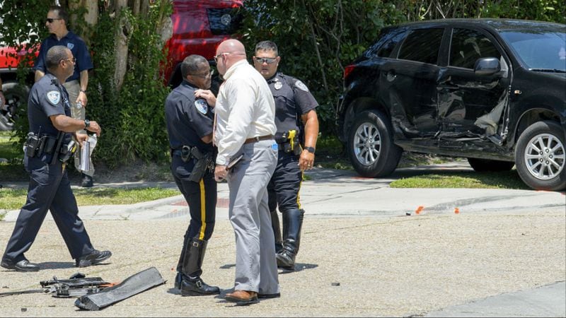Jefferson County sheriff's deputies investigate the scene Thursday, May 10, 2018, after Keeven Robinson, 22, died in police custody. At right is Robinson's SUV, which was damaged when he struck multiple patrol cars. Jefferson Parish Coroner Dr. Gerry Cvitanovich announced Monday, May 14, that Robinson died of compression asphyxia during his arrest by narcotics detectives.