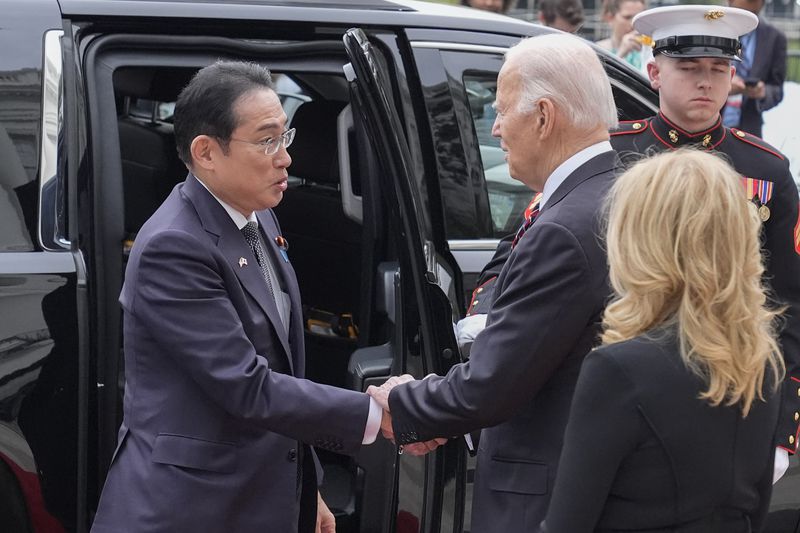 President Joe Biden, center, and first lady Jill Biden greet Japanese Prime Minister Fumio Kishida, left, upon his arrival at the White House, Tuesday, April 9, 2024, in Washington. (AP Photo/Alex Brandon)