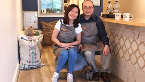 Bela, a Holland Lop rabbit, sits at the feet of Lucy Liu (left) and Ben Li of Belux Coffee Roasters. The pet bunny inspired the name of their company, and his image is on their logo. CONTRIBUTED BY DEBORA FANG