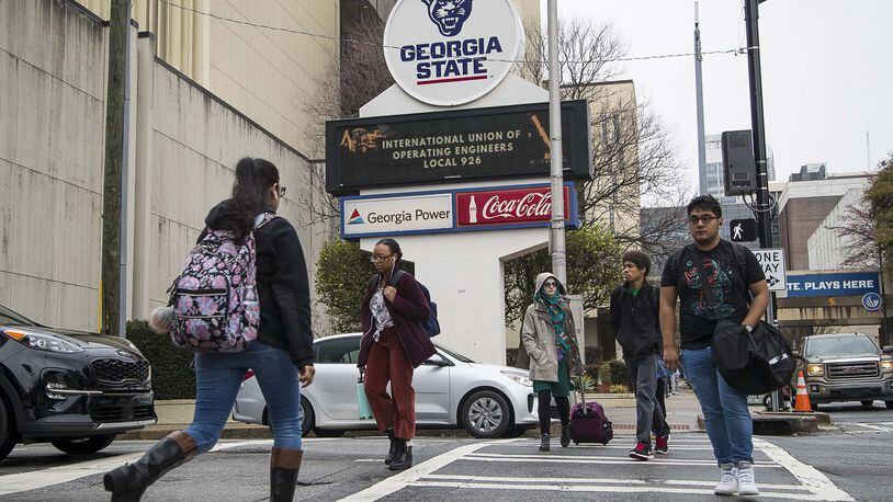Students navigate Georgia State University’s main campus in Atlanta, Tuesday, March 10, 2020. Georgia State and other Georgia colleges and universities moved to online classes in the face of the mounting coronavirus threat.