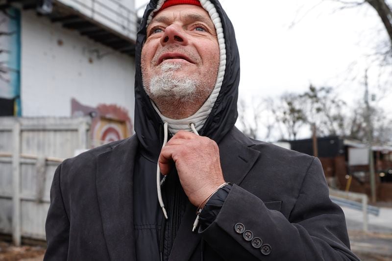 Mark Jones, who has been homeless at times for about five years, shows off the layers of clothes he wears to stay warm on Friday, December 29, 2023. (Natrice Miller/ Natrice.miller@ajc.com)