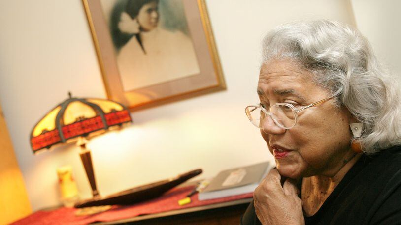 June Dobbs Butts in her Decatur apartment in January 2006. A picture of her mother is on the wall in the background. (Louie Favorite / AJC file)