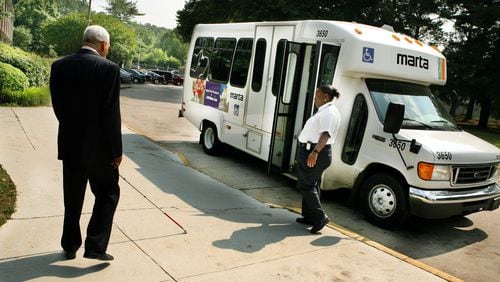 A man who is visually impaired makes his way to a MARTA paratransit vehicle in Atlanta. (JOEY IVANSCO/ AJC staff/ May 2006 file photo)