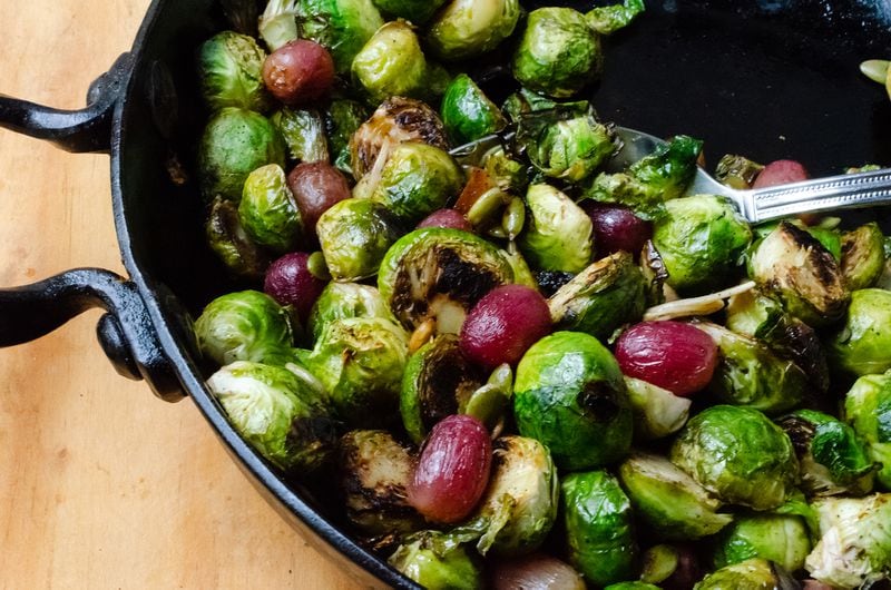Add a serving of vegetables and a serving of fruit to your meal with Brussels Sprouts with Garlic and Grapes. (Virginia Willis for The Atlanta Journal-Constitution)