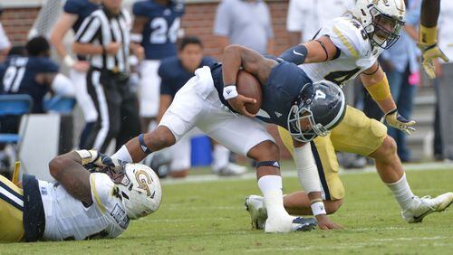 Georgia Southern quarterback Kevin Ellison (4) gets tackled by Georgia Tech defensive lineman Kyle Cerge-Henderson (left) in the second half at Bobby Dodd Stadium on Saturday, October 15, 2016. Georgia Tech won 35-24 over the Georgia Southern. HYOSUB SHIN / HSHIN@AJC.COM