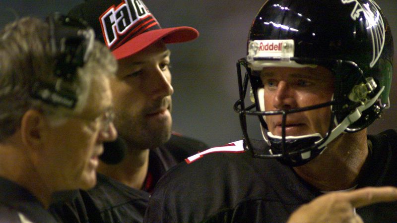 Dan Reeves (left) directs quarterback Steve DeBerg on August 28, 1998. (AJC Staff Photo/David Tulis)