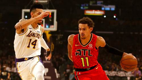 Hawks guard Trae Young (right) moves the ball down the court as the Lakers' Danny Green trails during the first half Nov. 17, 2019, at Staples Center in Los Angeles.
