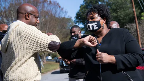U.S. Sen. Raphael Warnock and Georgia gubernatorial Stacey Abrams will campaign together today. In the photo, they are greeting one another at a 2020 event. (File photo)