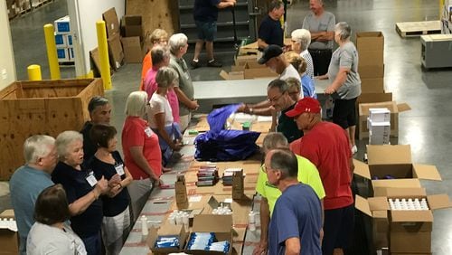 Volunteers at MAP International in Brunswick assemble relief health kits to be taken to Texas to help victims of Hurricane Harvey. CONTRIBUTED