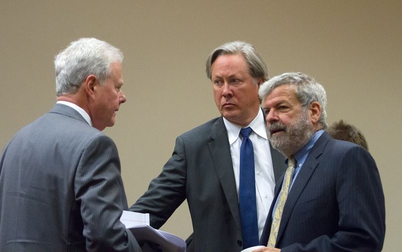 Former DeKalb County Police Officer Robert Olsen (center) talks with his defense team — including co-counsel Don Samuel (right) — during a morning break in Olsen’s pretrial immunity hearing at the DeKalb County Superior Court in Decatur, Ga., on Tuesday, May 22, 2018. 