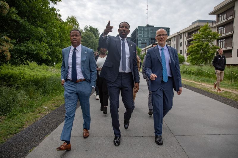 From left: BeltLine, Inc. CEO and President Clyde Higgs, Atlanta Mayor Andre Dickens and White House Senior Advisor Tom Perez stroll down the eastside trail of the Beltline on April 24, 2024 ahead of an announcement that a majority of the trail loop will be completed ahead of the 2026 FIFA World Cup.