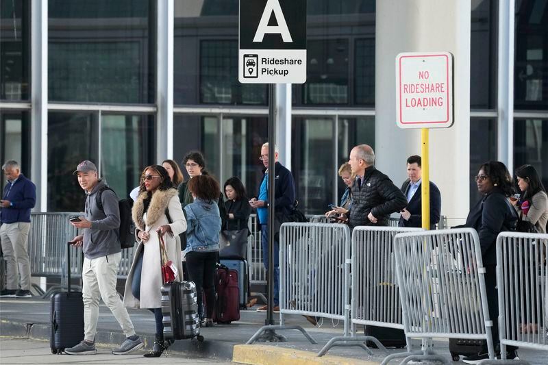Travellers wait for their ride at O'Hare International Airport in Chicago, Monday, April 15, 2024. Pro-Palestinian demonstrators blocked a freeway leading to three Chicago O'Hare International Airport terminals Monday morning, temporarily stopping vehicle traffic into one of the nation's busiest airports and causing headaches for travelers. (AP Photo/Nam Y. Huh)