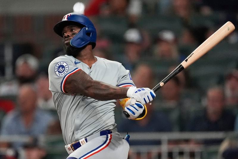 Texas Rangers' Adolis García drives in two runs with a double in the fifth inning of a baseball game against the Atlanta Braves Friday, April 19, 2024, in Atlanta. (AP Photo/John Bazemore)
