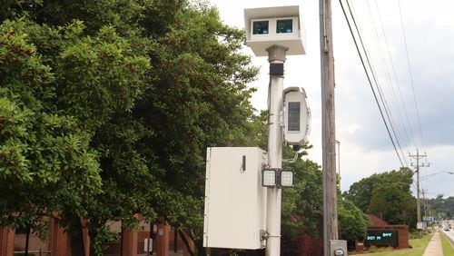 A speed camera on U.S. Highway 78 next to South Gwinnett High School in Snellville. The cameras capture video footage and the license plate of people driving 11 mph or higher over the posted speed limit an hour before and after and while class is in session. (Tyler Wilkins / tyler.wilkins@ajc.com)