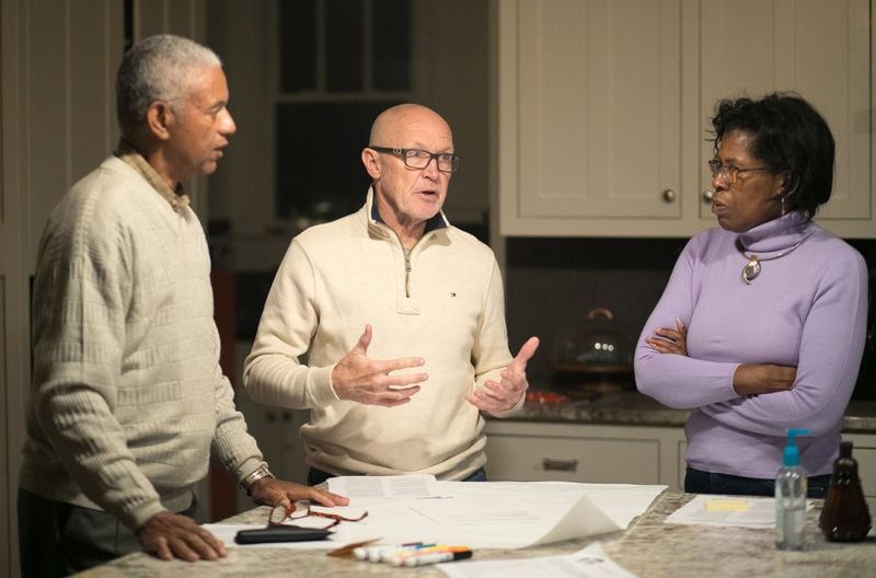 After their Healing the Racial Divide group split into small groups, Charles Williams (left) of Norcross, Owen Janeway (center) of east Cobb and Lynne Anderson of Rockdale County discuss a historical view about racism. JASON GETZ / SPECIAL
