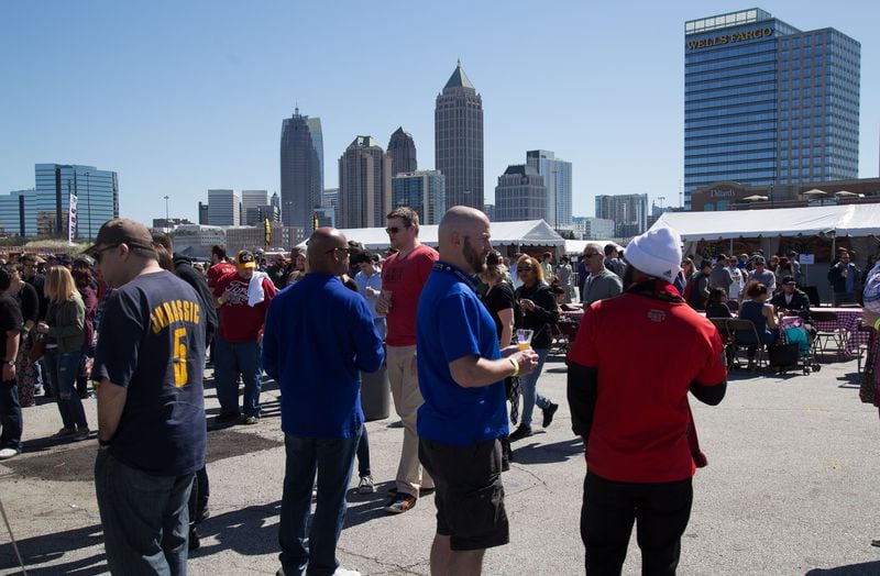 Some of the estimated 6500 participants enjoy the spring-like weather as they sample some of the 40 Bourbons and 60 Beers on Tap at the  Beer Bourbon & BBQ Festival at Atlantic Station Saturday, March 3, 2018.  STEVE SCHAEFER / SPECIAL TO THE AJC