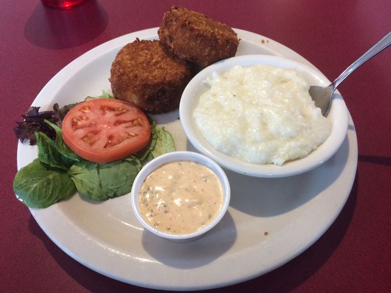 Atlanta Breakfast Club’s salmon croquettes are served with grits and remoulade sauce. CONTRIBUTED BY WENDELL BROCK