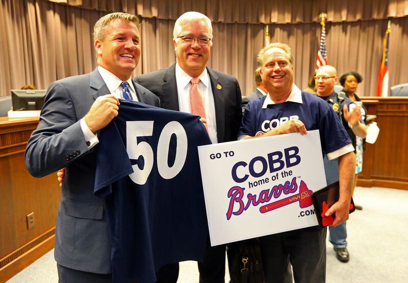 Cobb County Chairman Tim Lee (center) celebrates the Braves move to Cobb