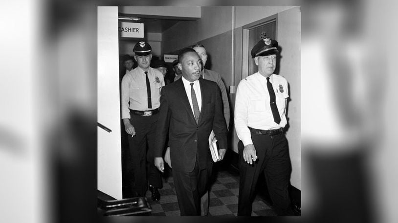 In this Oct. 25, 1960 AP file photo, Martin Luther King Jr. leaves court in Decatur after being given a four-month sentence related to a recent arrest at a sit-in. (AP Photo, File)