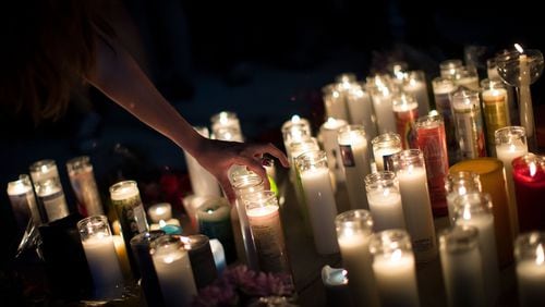 Mourners light candles in memory of the Las Vegas shooting victims. Photo by Drew Angerer/Getty Images