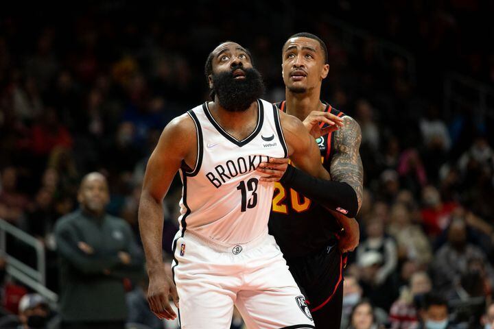 The Nets' James Harden (13) guards The Hawks' John Collins (20) during a game between the Atlanta Hawks and the Brooklyn Nets at State Farm Arena in Atlanta, GA., on Friday, December 10, 2021. (Photo/ Jenn Finch)