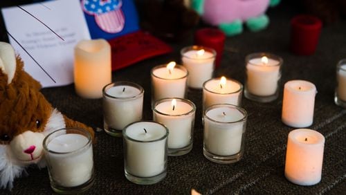 Candles sit in front of a memorial during a candlelight vigil last week in Acworth. The Atlanta spa shootings are the latest incident that are driving increased demand for mental health services, including among Asian Americans. (CHRISTINA MATACOTTA FOR THE ATLANTA JOURNAL-CONSTITUTION)