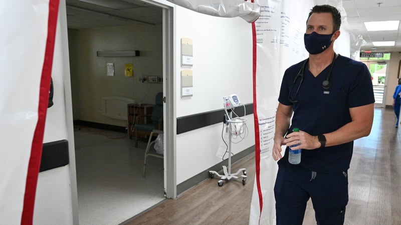 In this file photo, Dr. Jason Laney walks back to an intensive care unit (ICU) at Jeff Davis Hospital in Hazlehurst on Monday, September 13. (Hyosub Shin / Hyosub.Shin@ajc.com)