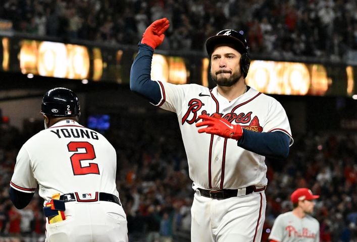 Atlanta Braves catcher Travis d'Arnaud (16) celebrates an RBI single against the Philadelphia Phillies during the sixth inning of game two of the National League Division Series at Truist Park in Atlanta on Wednesday, October 12, 2022. (Hyosub Shin / Hyosub.Shin@ajc.com)