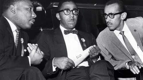 Lowery (middle) sits with Rev. Martin Luther King Jr. (left) and Wyatt Tee Walker at the First African Baptist Church during an SCLC convention in Richmond. File photo