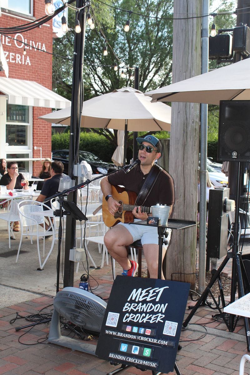 Brandon Crocker performs in the courtyard between Fogón and Lions, a Spanish and Latin eatery, and Minnie Olivia Wood Fire Pizzeria in Alpharetta. 
Photo: Courtesy of Gracie Waylock