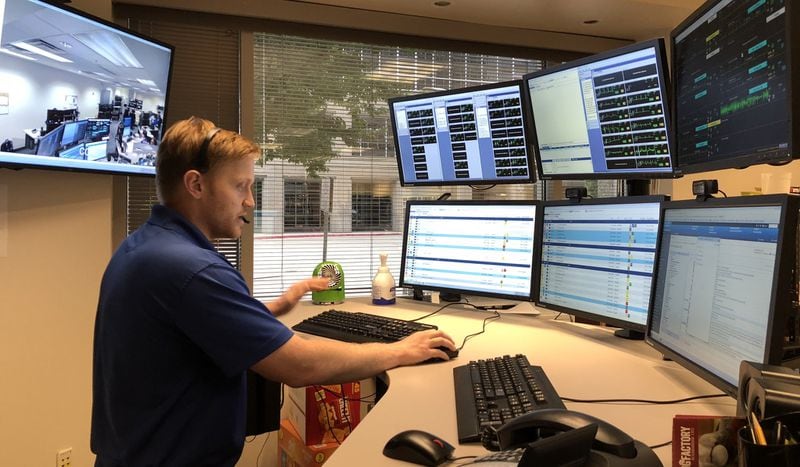 Nick Porter, a registered nurse, works at the eICU at Emory Johns Creek Hospital in 2018. The electronic intensive care unit allows doctors and nurses to examine patients remotely. File photo.