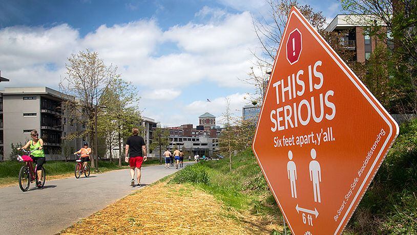 Signs are posted along the Beltline, urging people to stay separated in Atlanta, March 28, 2020. (STEVE SCHAEFER / Special to the AJC)