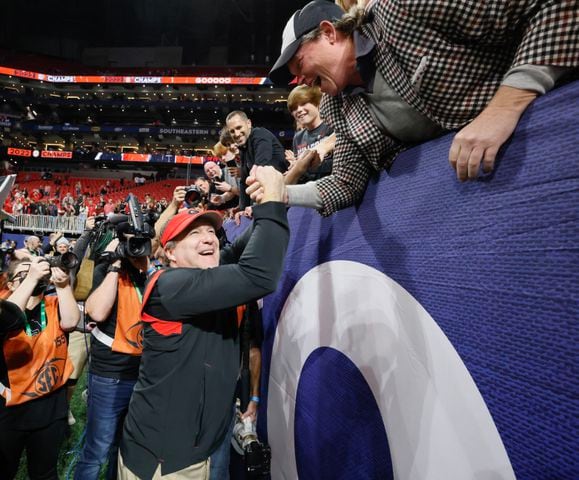 Georgia Bulldogs head coach Kirby Smart celebrates with fans after UGA defeated LSU 50 - 30 in the SEC Championship between the Georgia Bulldogs and the LSU Tigers In Atlanta on Saturday, Dec. 3, 2022. (Bob Andres / Bob Andres for the Atlanta Constitution)
