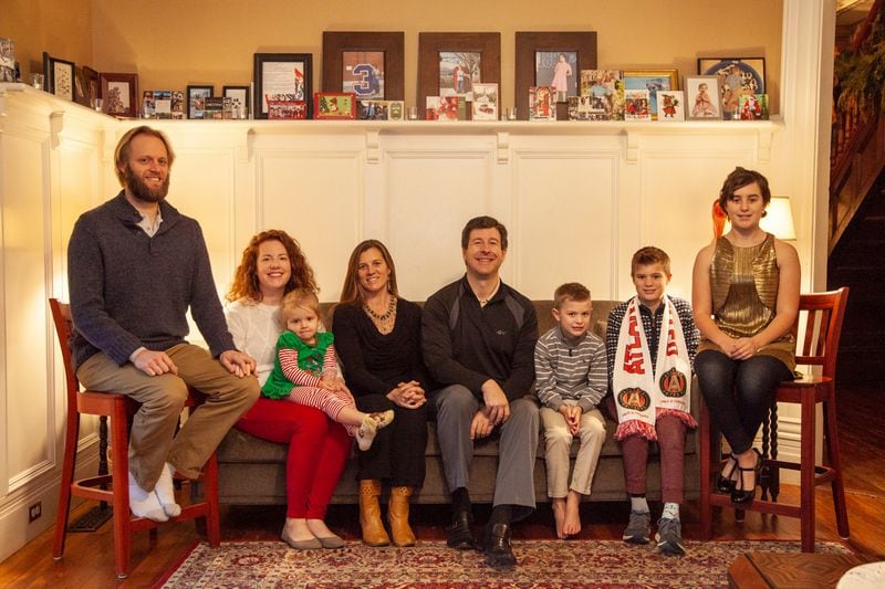 Matthew and Erin Miller (center) live in the 1868 Queen Anne-style home with their children, Baikal, 13, Rybolt, 11, and Garvin, 7, and their Saint Bernards, Atunda and Angus. Erin's cousin Ben Rybolt (left), his wife Kat, and their daughter Olive, 3, also live with the Millers.