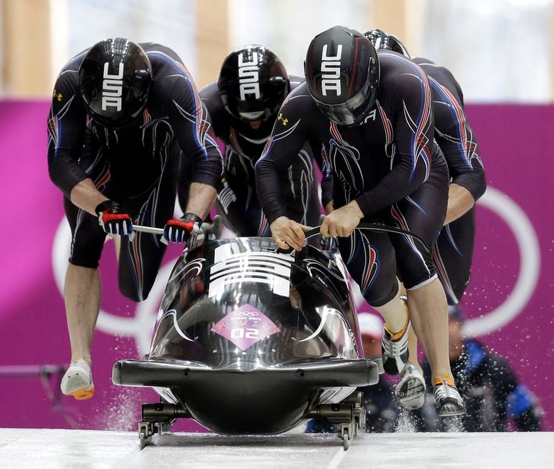 The bronze medal winning USA-1 team takes off during the four-man bobsled competition at the 2014 Winter Olympics in Sochi.  (AP Photo/Natacha Pisarenko)
