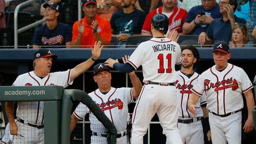 Ender Inciarte returns to the Braves dugout after scoring on a double hit by Freddie Freeman. (Photo by Kevin C. Cox/Getty Images)