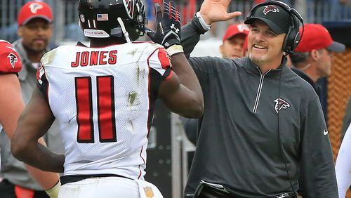102515 NASHVILLE: -- Falcons wide receiver Julio Jones gets a high five from head coach Dan Quinn after scoring the game winning touchdown for a 10-7 victory over the Titans in a football game on Sunday, Oct. 25, 2015, in Nashville. Curtis Compton / ccompton@ajc.com
