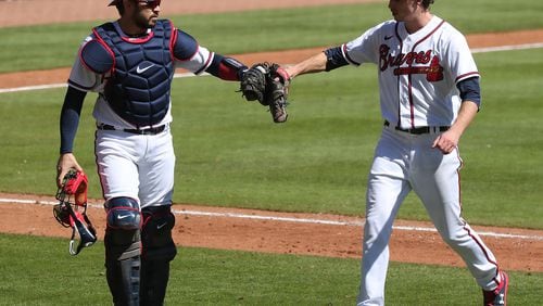 Braves pitcher Max Fried gets a glove bump from catcher Travis d’Arnaud during the sixth inning in Game 1 of the National League wild card playoff series on Wednesday, Sept. 30, 2020 in Atlanta. Curtis Compton / Curtis.Compton@ajc.com